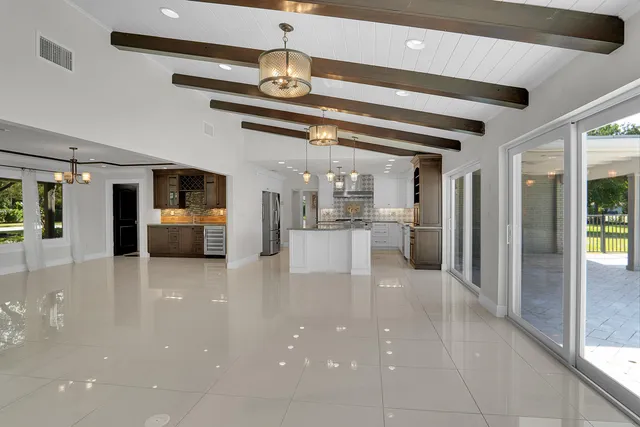 a view of a living room and kitchen with stainless steel appliances