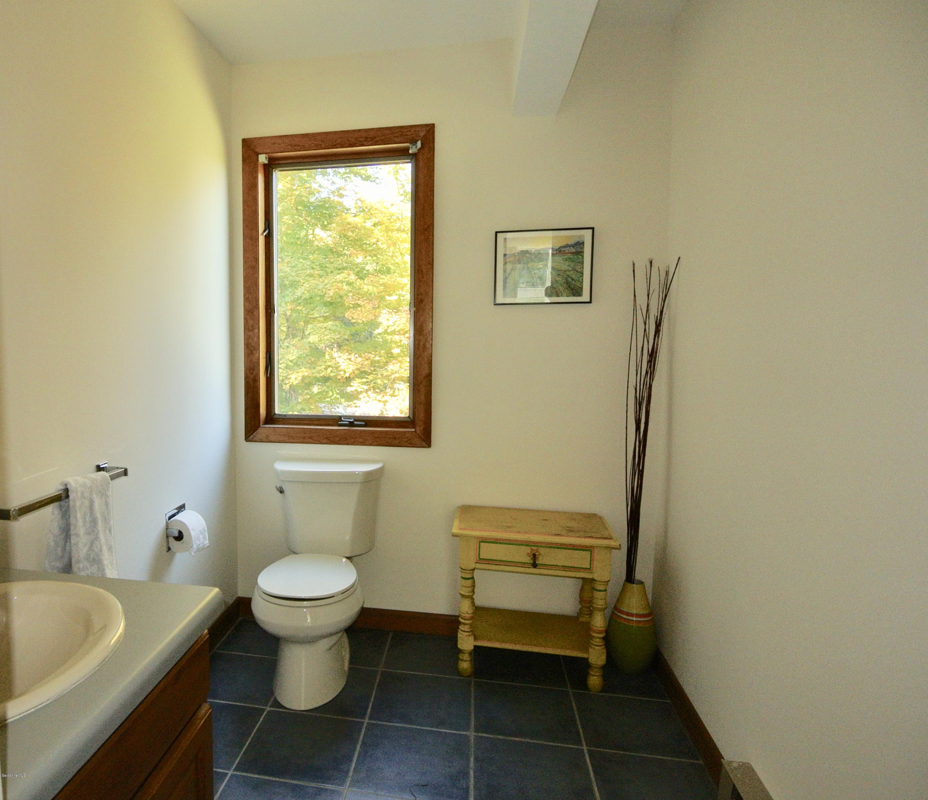 101 Judd Road Otis, MA 01253 - Photo 14 of 29 a bathroom with a granite countertop toilet a sink and a bathtub