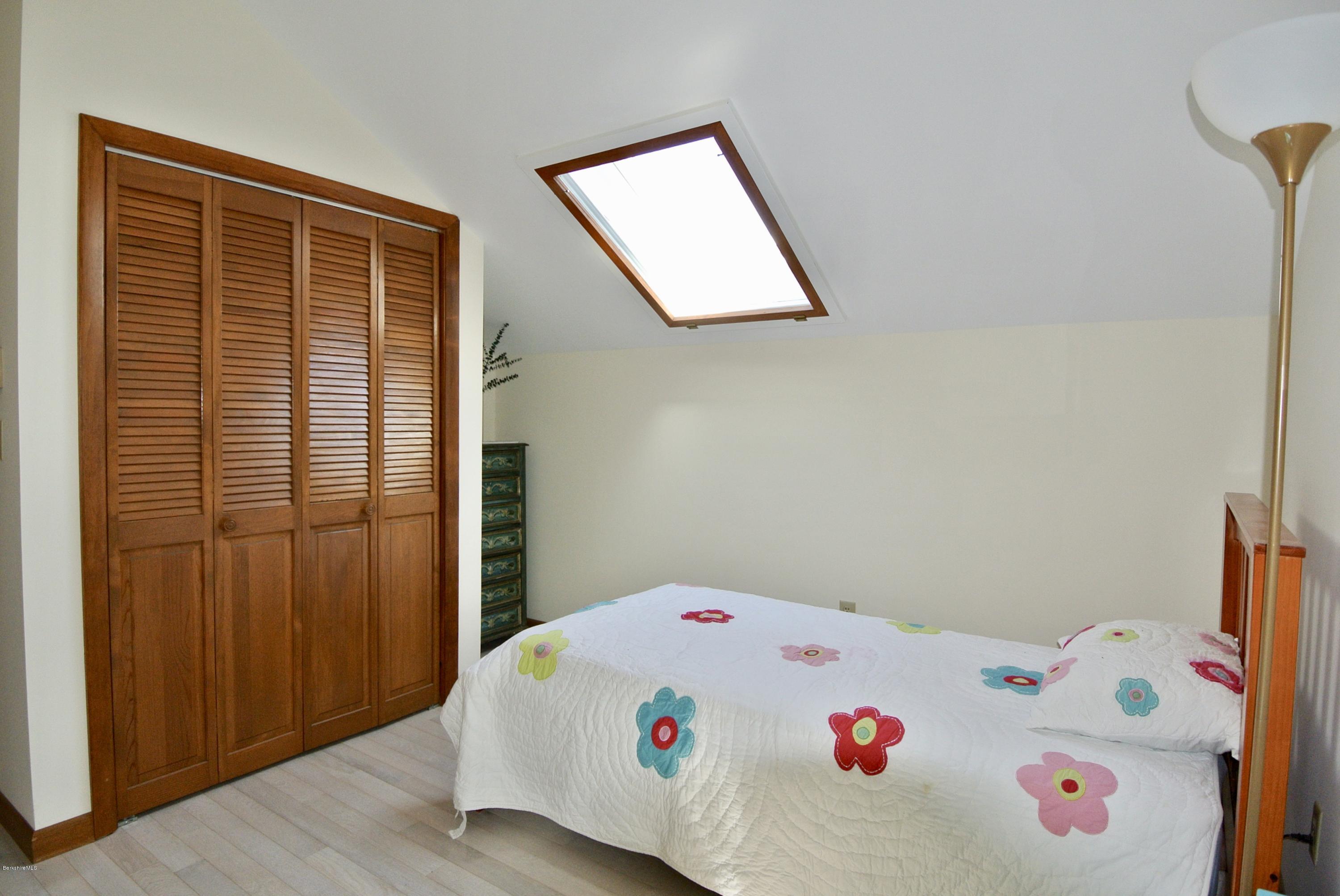 101 Judd Road Otis, MA 01253 - Photo 16 of 29 a white bed sitting in a bedroom next to a window