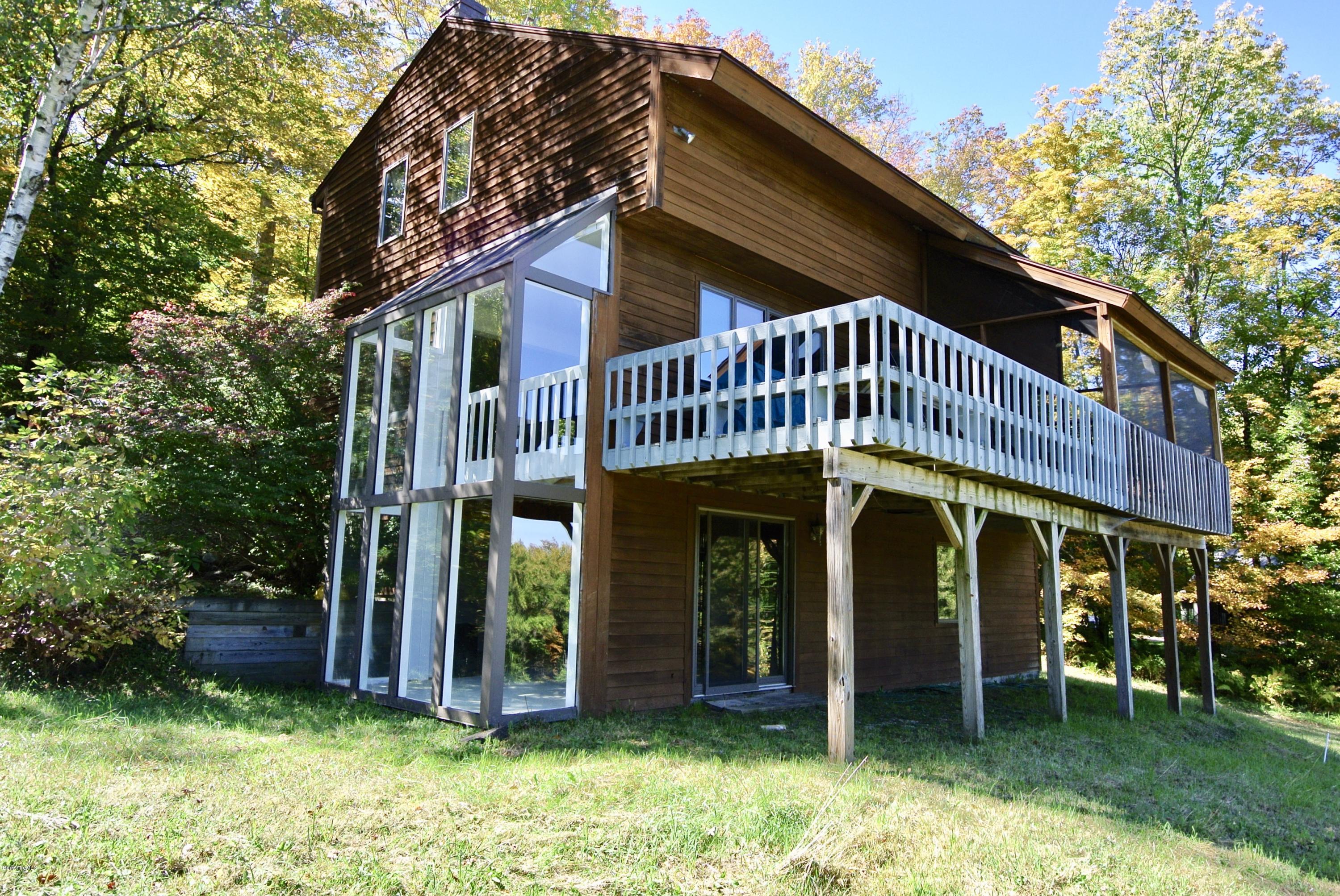 101 Judd Road Otis, MA 01253 - Photo 25 of 29 a view of a house with a yard balcony and wooden fence