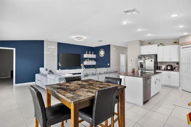 a kitchen with granite countertop a sink and white cabinets
