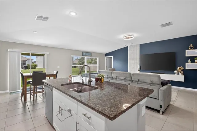 a kitchen with granite countertop a sink and a counter top space
