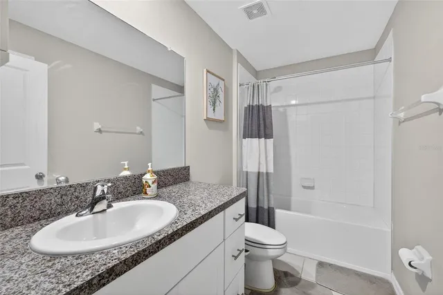 a living room with furniture and a ceiling fan