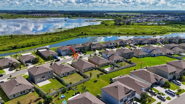 a aerial view of a house with a garden and lake view