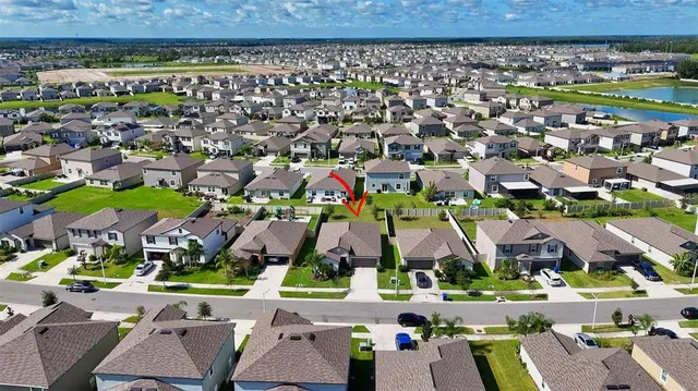 an aerial view of residential houses with outdoor space