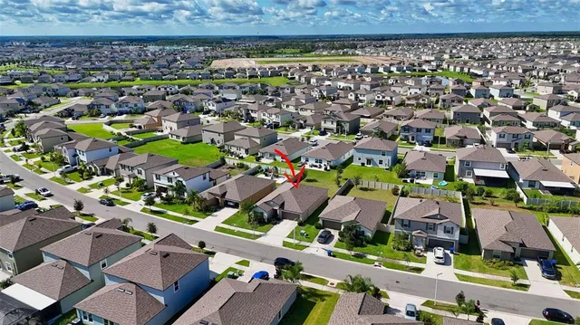 a front view of a house with a yard and potted plants