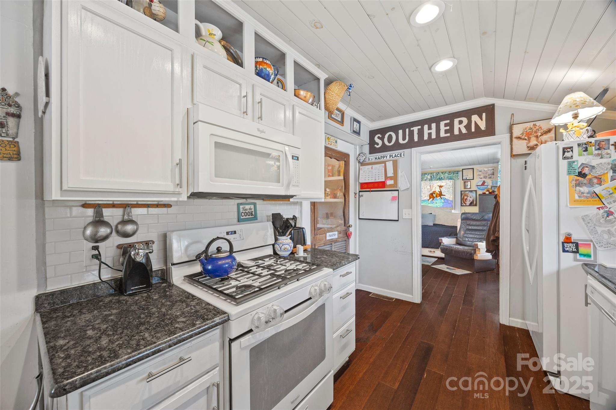 205 East Jefferson Street York, SC 29745 - Photo 14 of 35 a kitchen with stainless steel appliances granite countertop a stove and cabinets