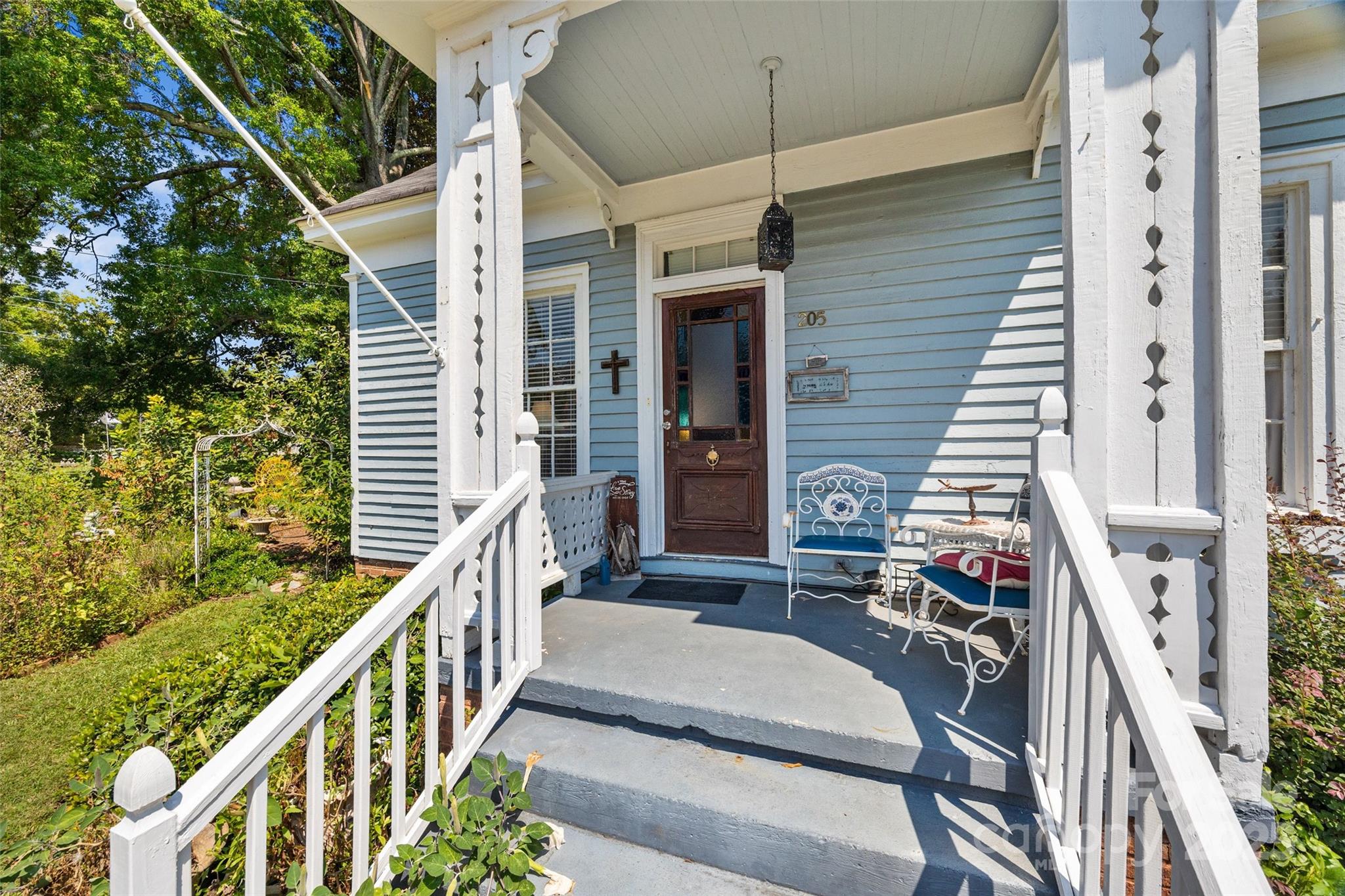205 East Jefferson Street York, SC 29745 - Photo 3 of 35 a balcony view with a couple of flower plants