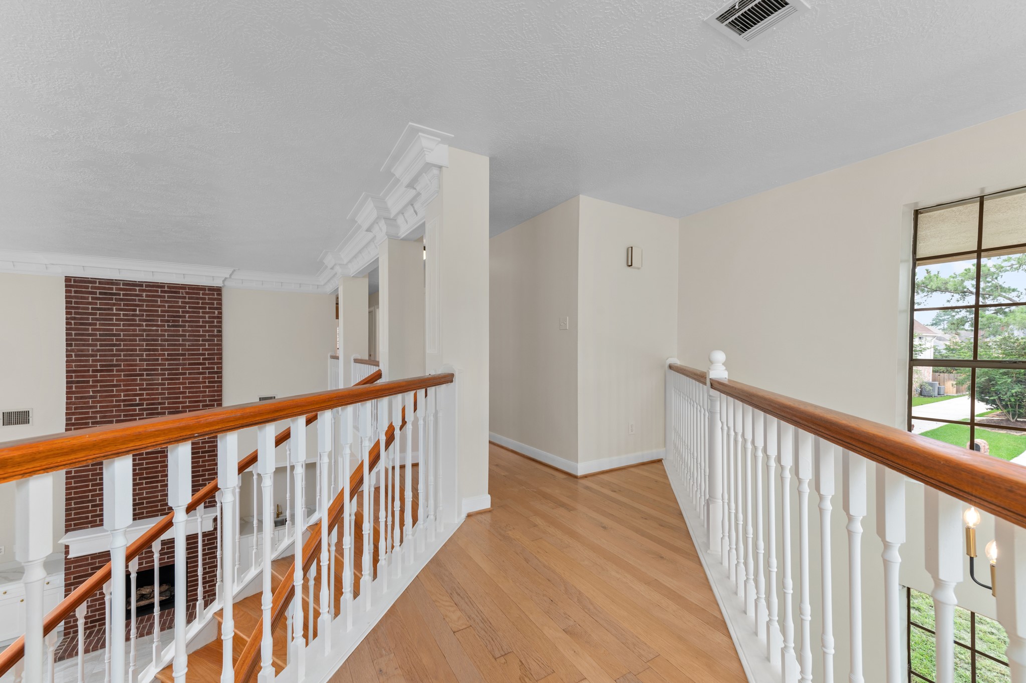 17402 Wilton Park Court Spring, TX 77379 - Photo 42 of 50 a view of a hallway with wooden floor and windows