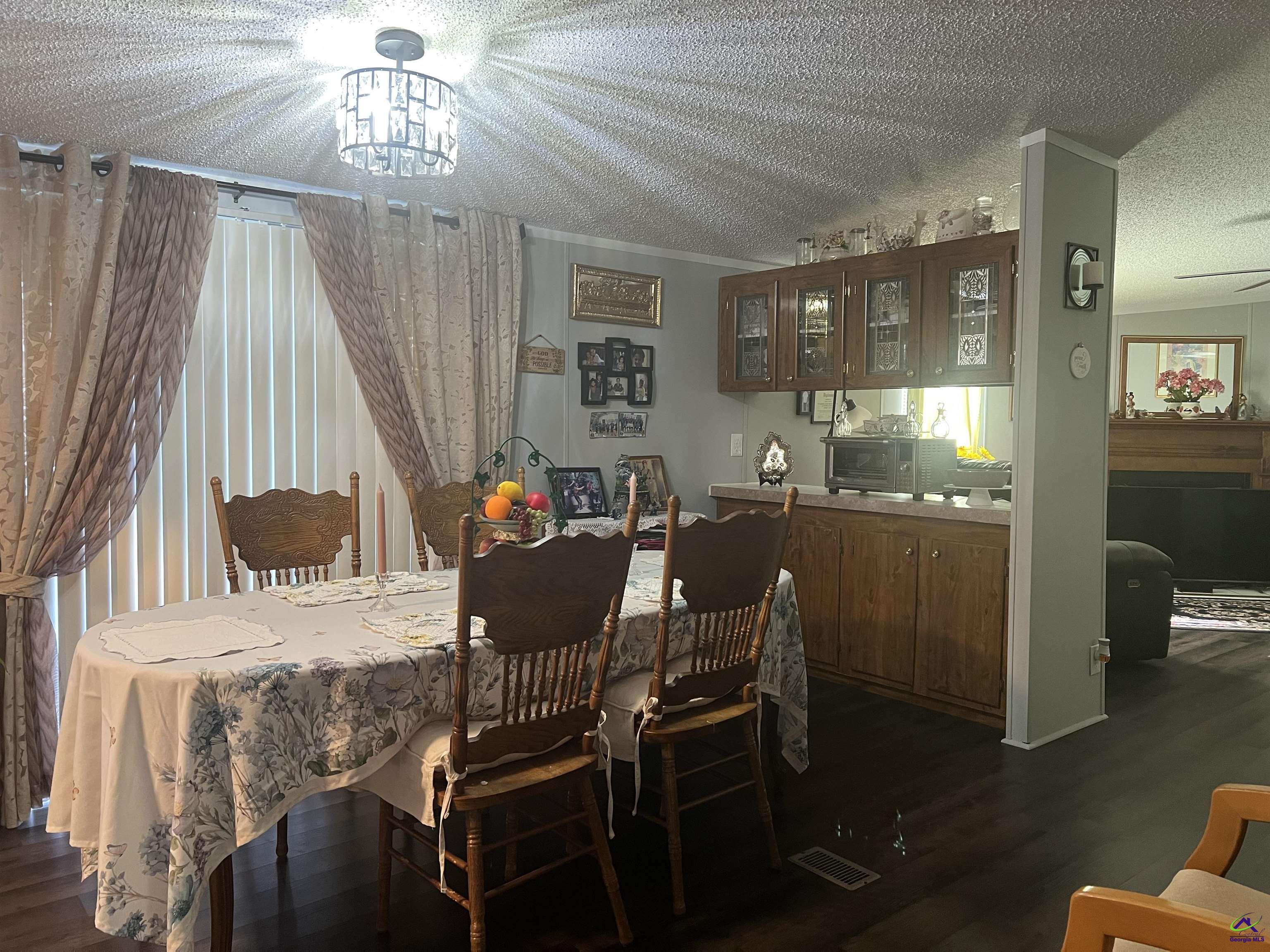 166 Pebble Hills Road Cochran, GA 31014 - Photo 14 of 27 a view of a dining room with furniture and chandelier