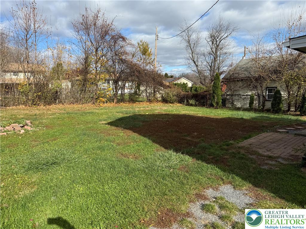 2955 Middletown Road Bethlehem, PA 18020 - Photo 19 of 20 A spacious yard offers ample green space and a quaint brick patio, perfect for outdoor enjoyment.