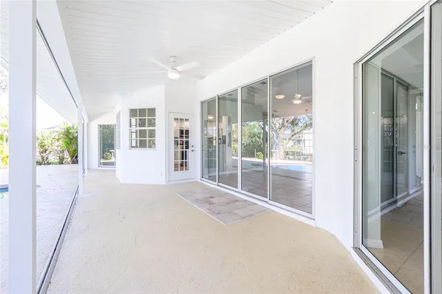 a living room with furniture a flat screen tv and a large window