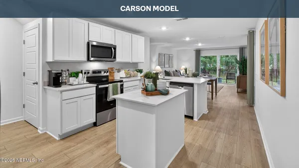 a kitchen with a sink a counter top space stainless steel appliances and cabinets