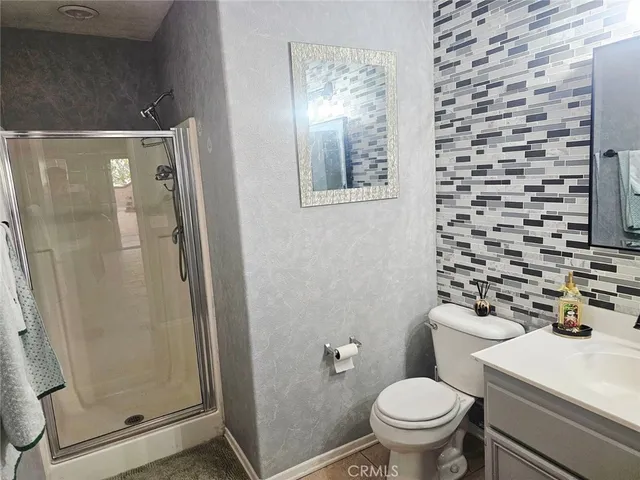 a bathroom with a toilet and a shower