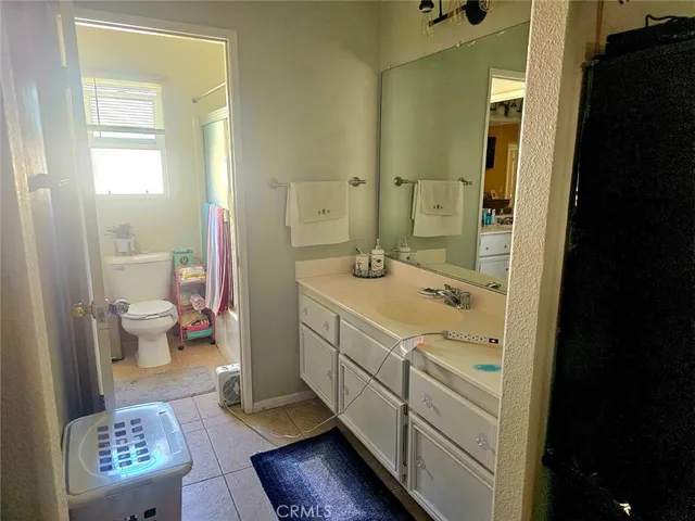 a spacious bathroom with a shower sink and toilet