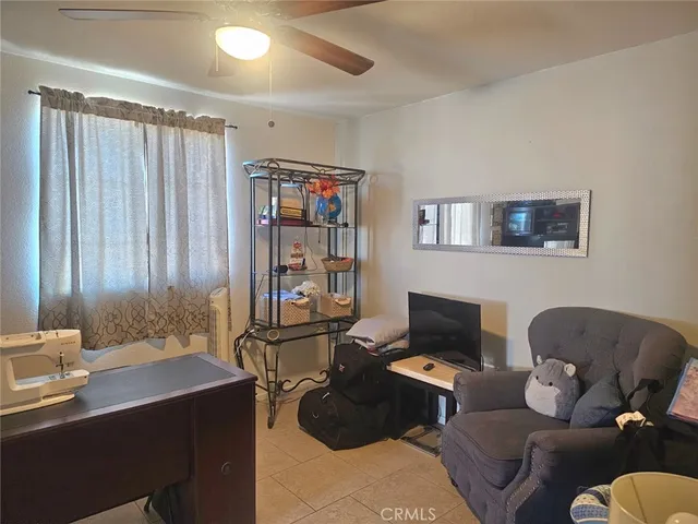 a living room with furniture a piano and a window