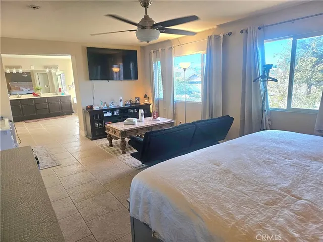 a bed room with a bed and a television