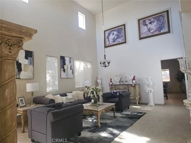 a living room with furniture and a chandelier