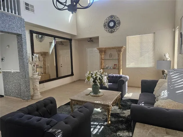 a living room with furniture and a large mirror
