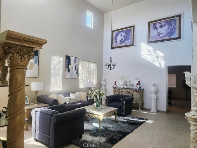 a living room with furniture a dining table and a fireplace