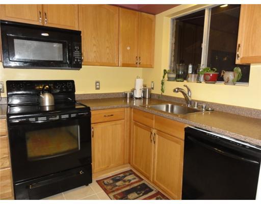 1615 Cheyenne Street Portland, TX 78374 - Photo 6 of 10 a kitchen with a sink stove and microwave