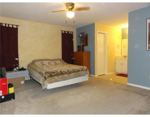 1615 Cheyenne Street Portland, TX 78374 - Photo 7 of 10 a bedroom with a bed and a chandelier