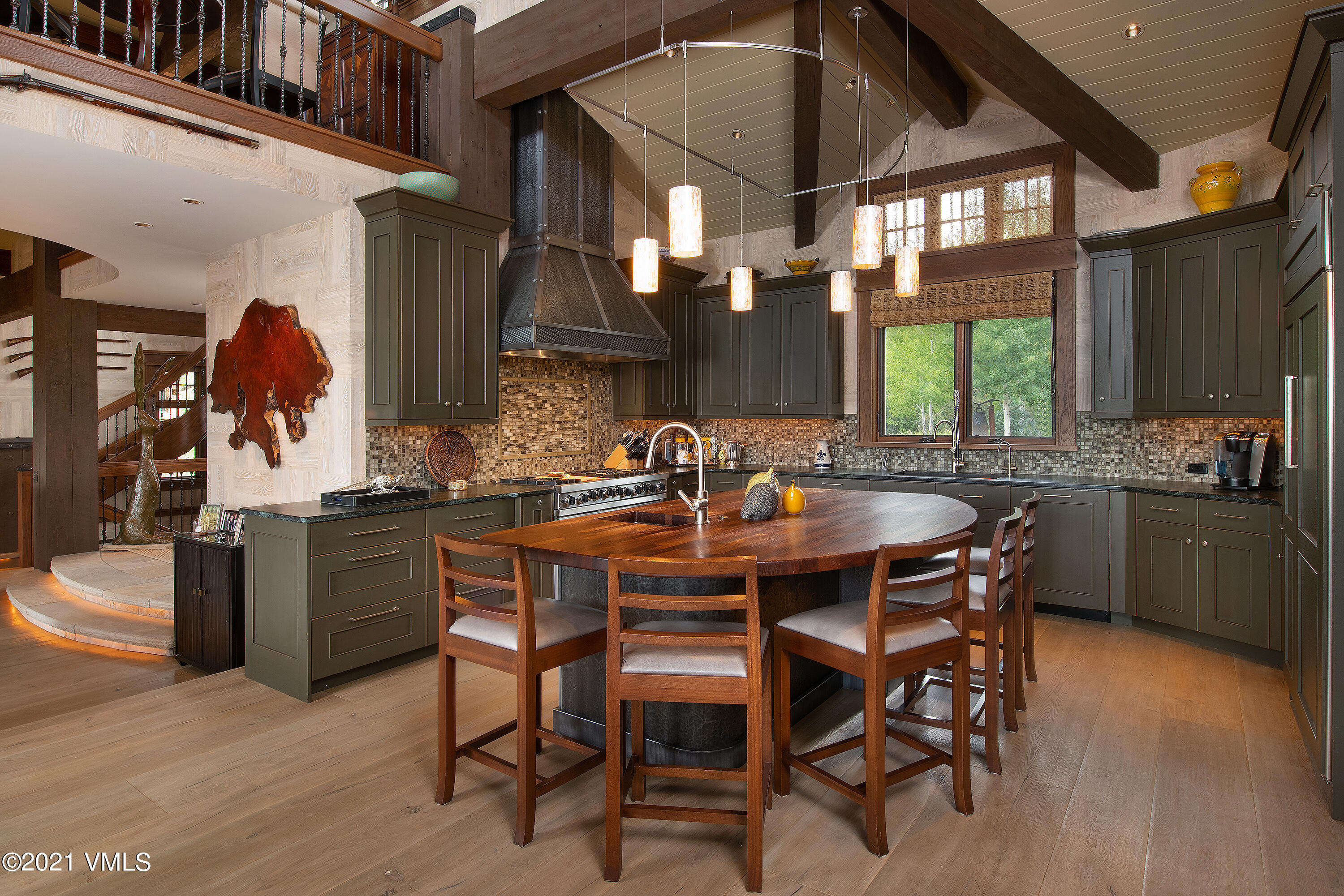 555 Red Draw Edwards, CO 81632 - Photo 9 of 24 a kitchen with a dining table chairs and white cabinets
