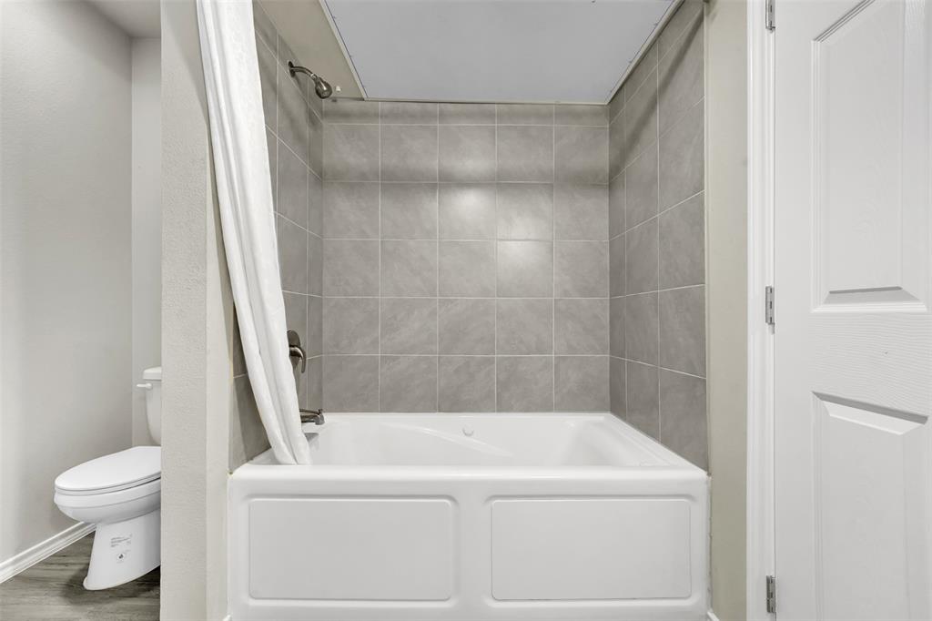 6108 Abrams Road, Unit 201 Dallas, TX 75231 - Photo 14 of 19 a white bath tub sitting next to a white toilet