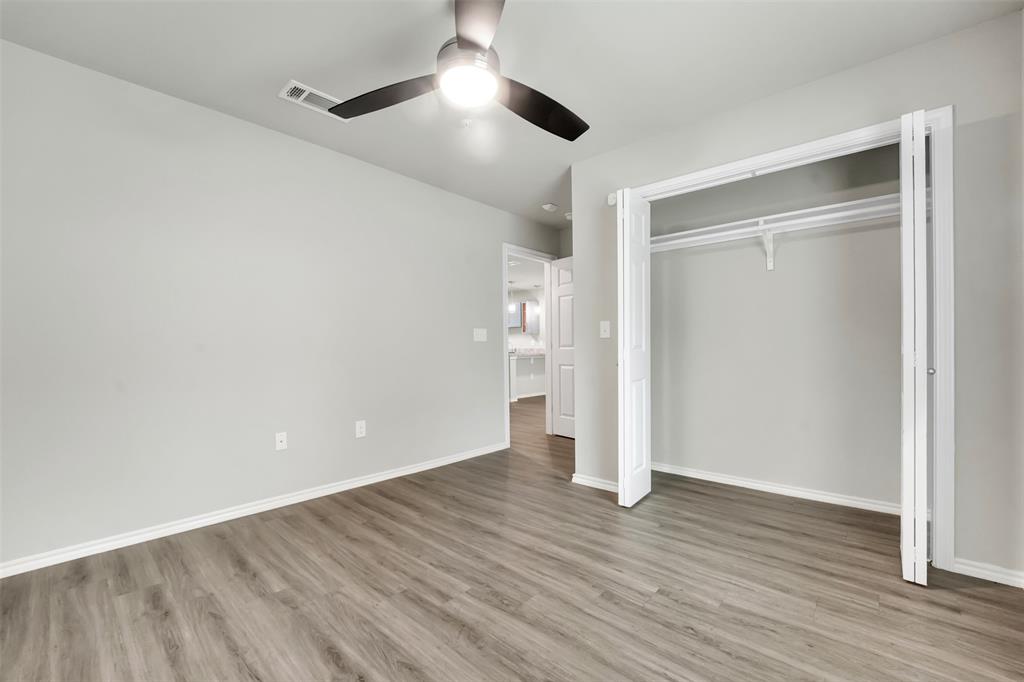 6108 Abrams Road, Unit 201 Dallas, TX 75231 - Photo 8 of 19 an empty room with wooden floor and ceiling fan