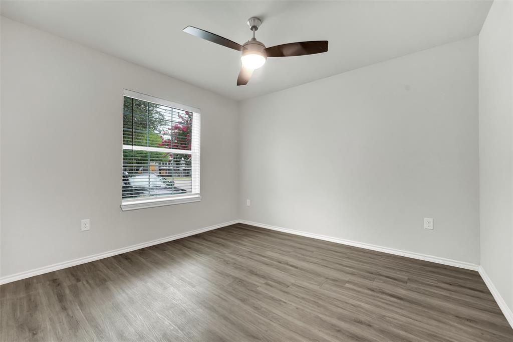 6108 Abrams Road, Unit 201 Dallas, TX 75231 - Photo 9 of 19 an empty room with wooden floor and windows