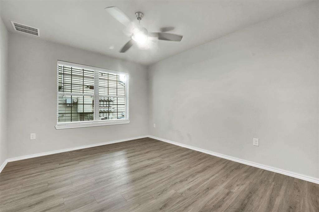 6108 Abrams Road, Unit 201 Dallas, TX 75231 - Photo 10 of 19 wooden floor in an empty room with a window