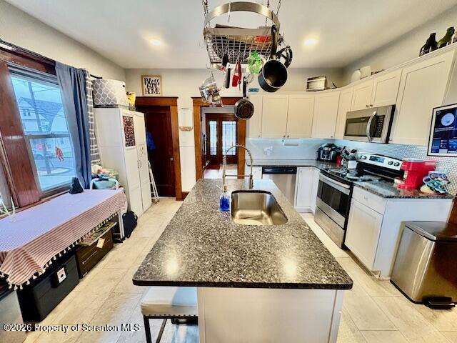 1200 Watson Street Scranton, PA 18504 - Photo 13 of 49 a kitchen with stainless steel appliances granite countertop a sink dishwasher stove top oven a dining table and chairs with wooden floor