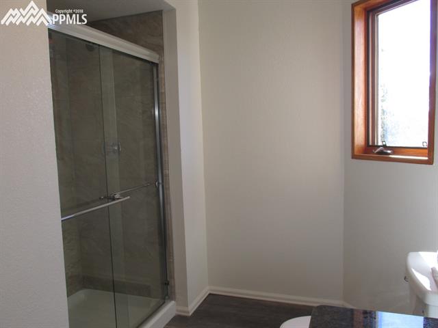 128 Wahsatch Road Florissant, CO 80816 - Photo 10 of 17 Main-level bath has brand-new tiled shower. There's plenty of room to put a cabinet or decorative shelving on the wall between the shower and window.