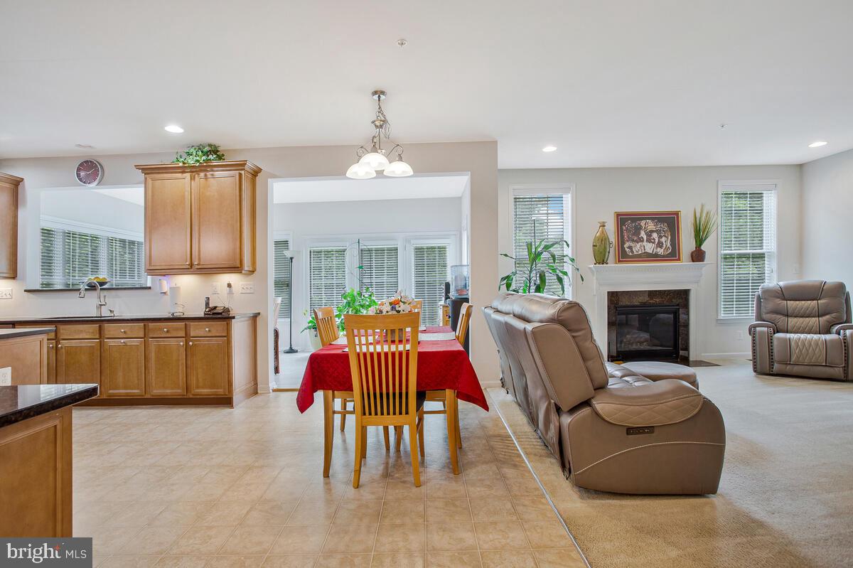 4006 Bridle Ridge Road Upper Marlboro, MD 20772 - Photo 17 of 45 a living room with furniture a fireplace and a kitchen view
