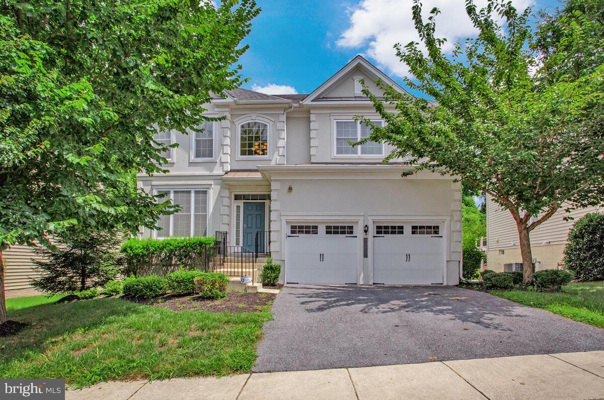 4006 Bridle Ridge Road Upper Marlboro, MD 20772 - Photo 2 of 45 a view of a white house with a yard and a large tree
