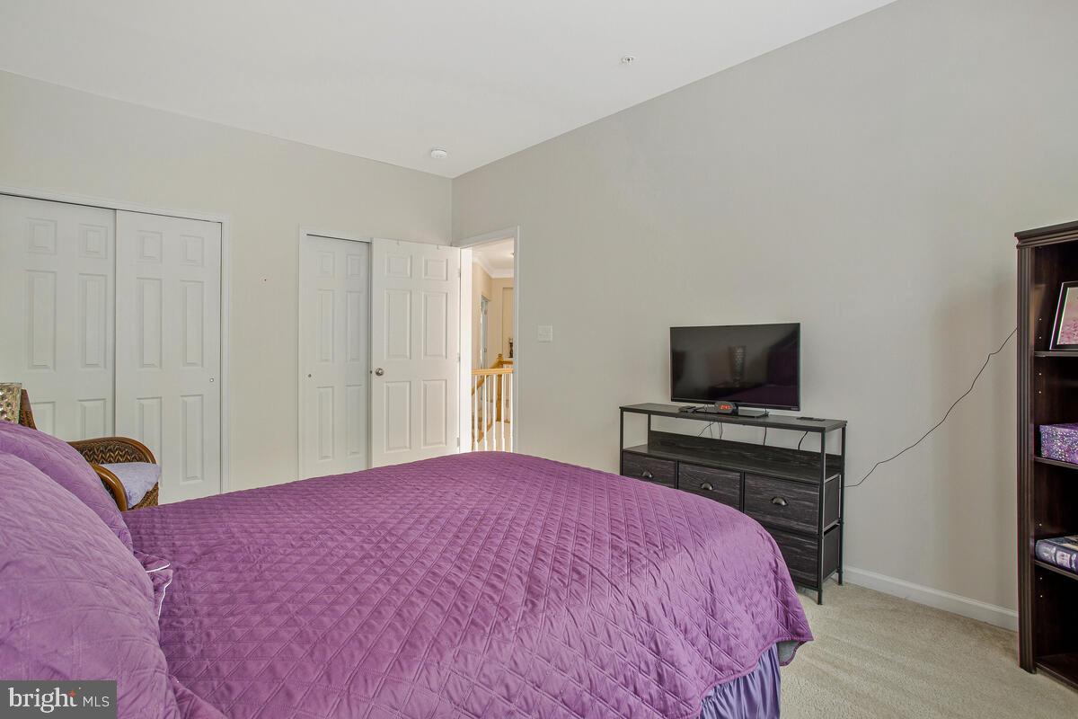 4006 Bridle Ridge Road Upper Marlboro, MD 20772 - Photo 33 of 45 a bedroom with a bed and a flat screen tv