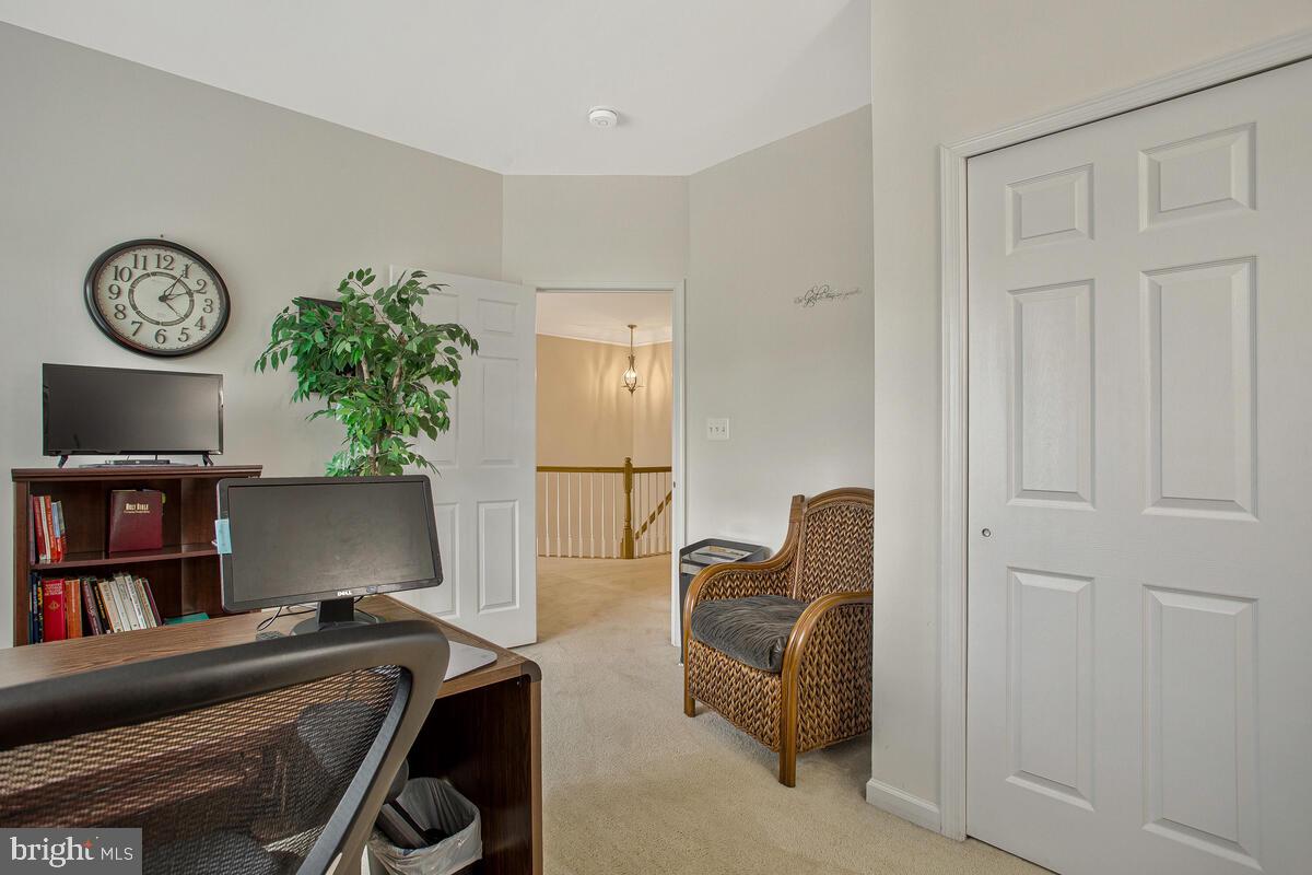 4006 Bridle Ridge Road Upper Marlboro, MD 20772 - Photo 35 of 45 a view of workspace with lounge chair and book shelf