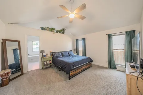 a bedroom with a bed and ceiling fan