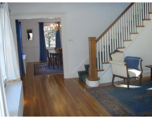 45 Elmwood Road Wellesley, MA 02481 - Photo 3 of 6 a hallway with wooden floor stairs and windows