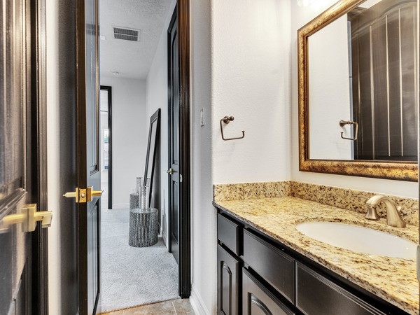2523 Watts Street Houston, TX 77030 - Photo 38 of 45 a bathroom with a granite countertop sink and a mirror