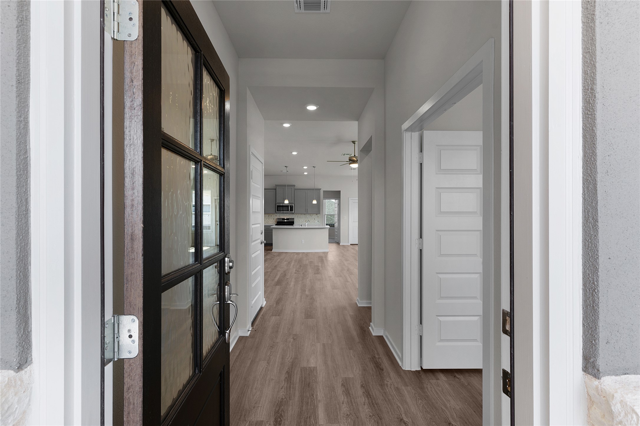 205 Blue Vervain Trail Georgetown, TX 78633 - Photo 2 of 27 a view of a hallway with wooden floor and a bathroom