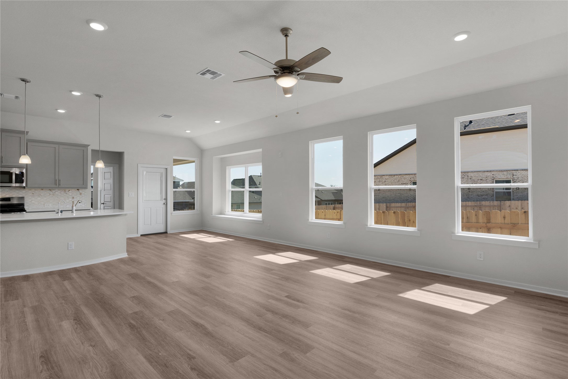 205 Blue Vervain Trail Georgetown, TX 78633 - Photo 5 of 27 a view of an empty room with a window and wooden floor