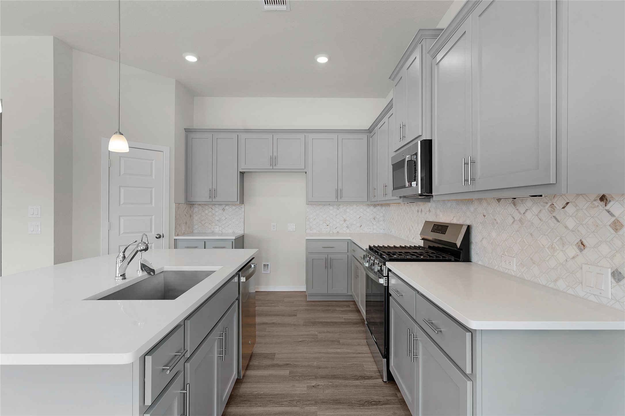 205 Blue Vervain Trail Georgetown, TX 78633 - Photo 7 of 27 a kitchen with a sink stove and cabinets