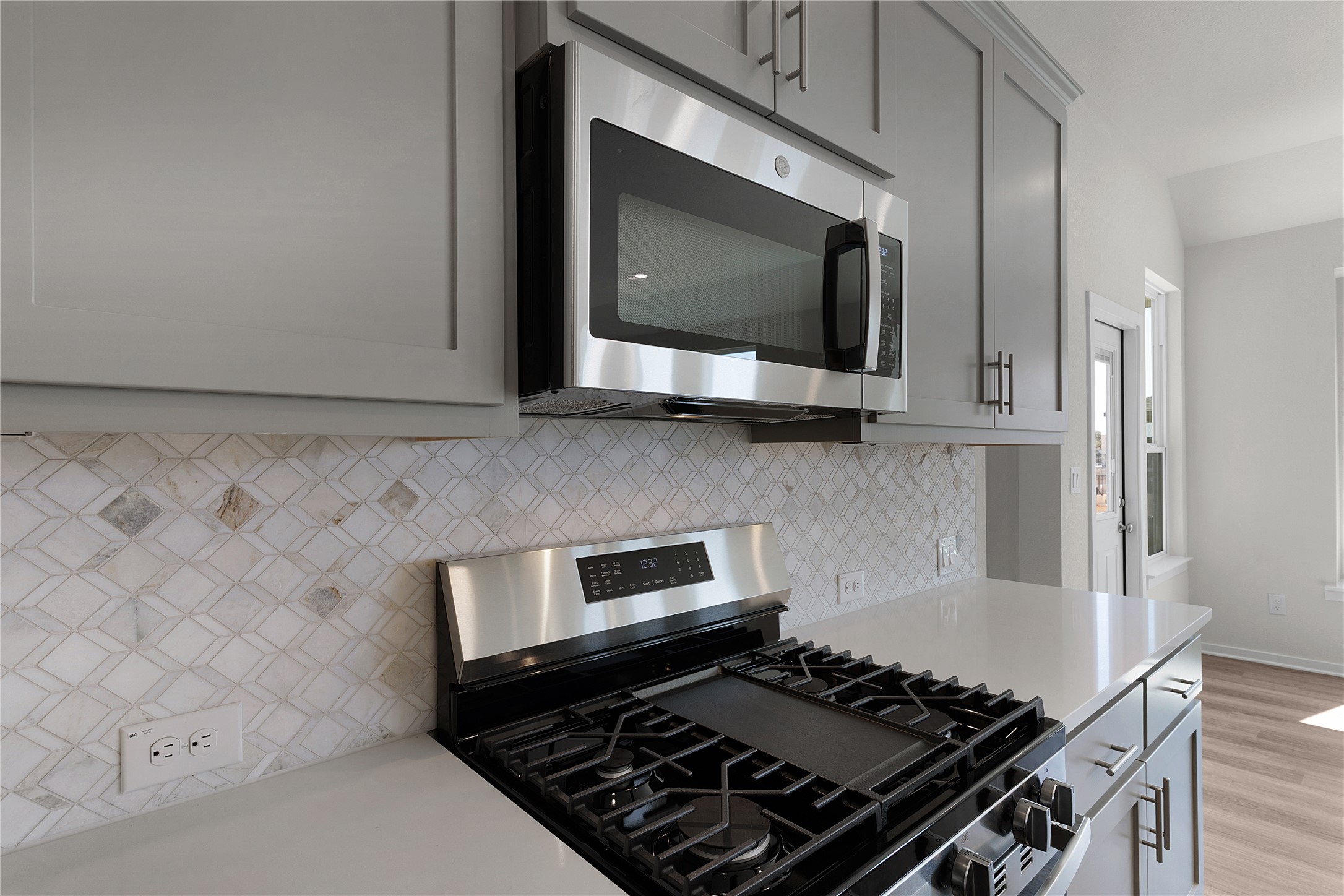 205 Blue Vervain Trail Georgetown, TX 78633 - Photo 8 of 27 a kitchen with a stove and a microwave