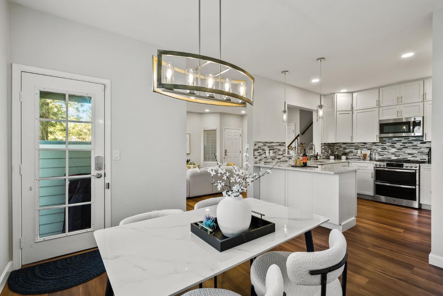 300 Troon Way Half Moon Bay, CA 94019 - Photo 13 of 50 a kitchen with stainless steel appliances kitchen island granite countertop a dining table chairs and granite counter tops