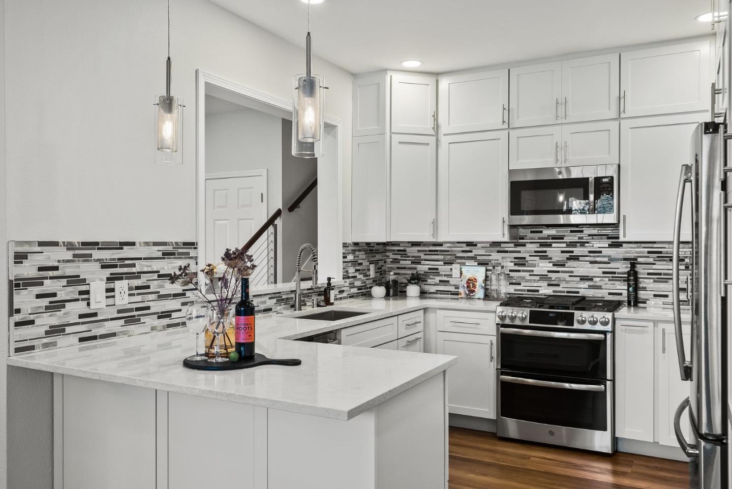 300 Troon Way Half Moon Bay, CA 94019 - Photo 14 of 50 a kitchen with a sink stainless steel appliances and cabinets