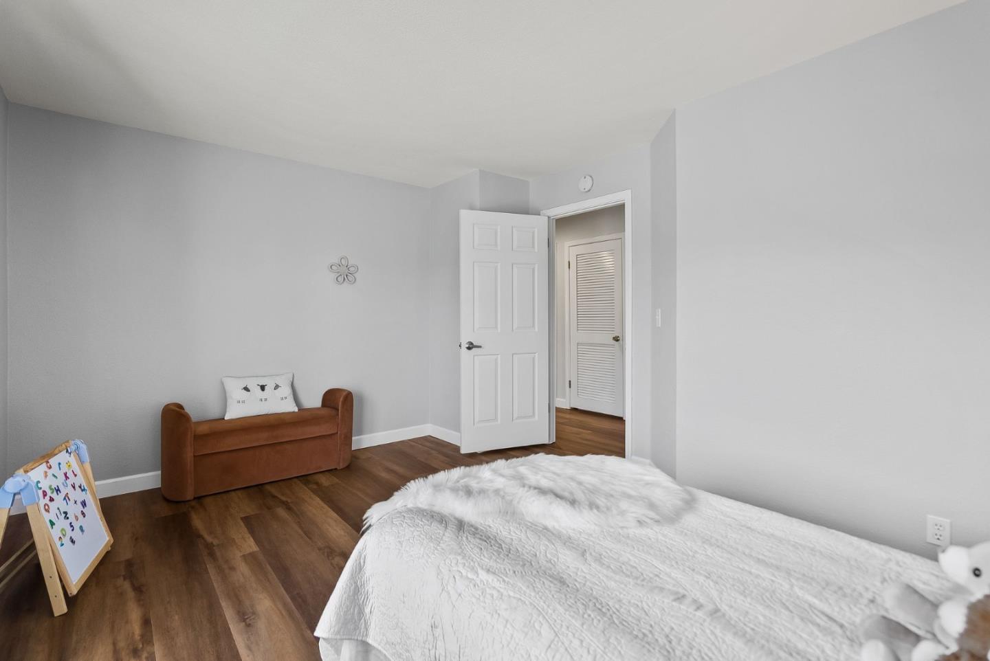 300 Troon Way Half Moon Bay, CA 94019 - Photo 27 of 50 a bedroom with bed and wooden floor