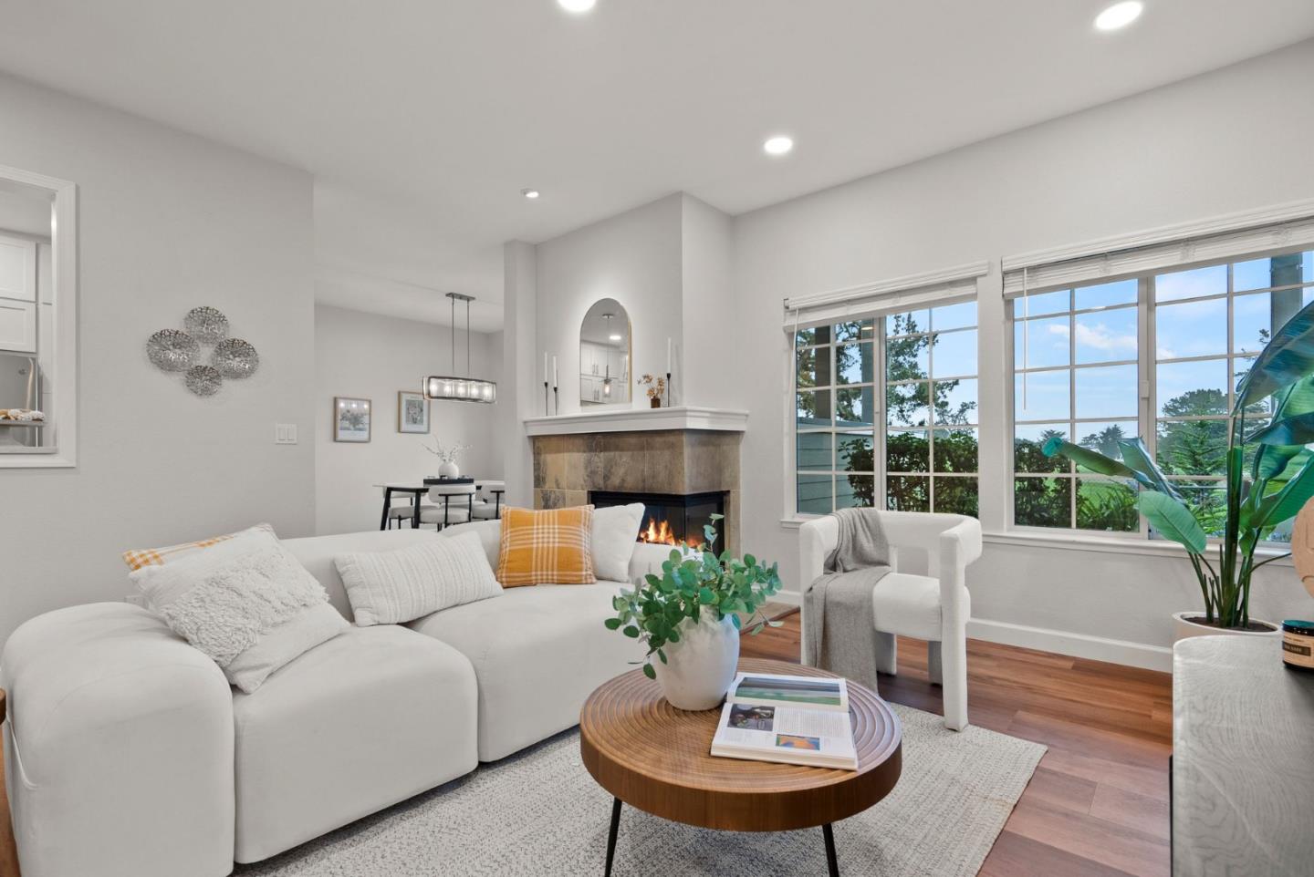 300 Troon Way Half Moon Bay, CA 94019 - Photo 4 of 50 a living room with furniture a large window and a fireplace