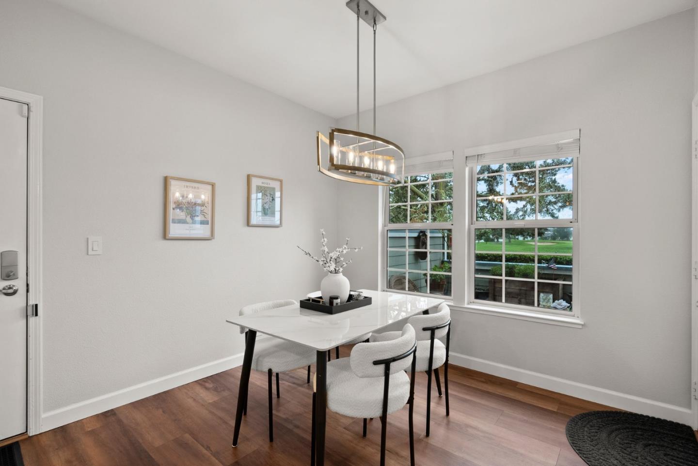 300 Troon Way Half Moon Bay, CA 94019 - Photo 10 of 50 a dining room with wooden floor a chandelier a wooden table and chairs