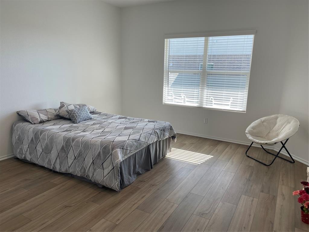 129 Starflower Cove Georgetown, TX 78628 - Photo 12 of 31 Bedroom featuring light wood-style flooring and baseboards